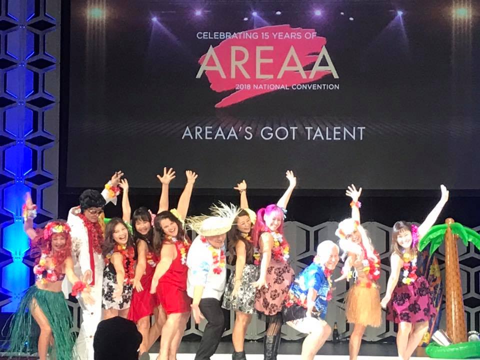 Members of Aloha AREAA chapter posing on stage