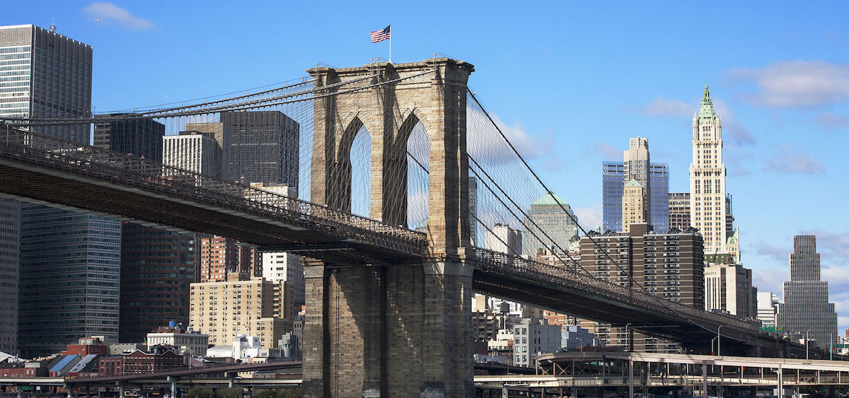 Brooklyn Bridge with a flag on top